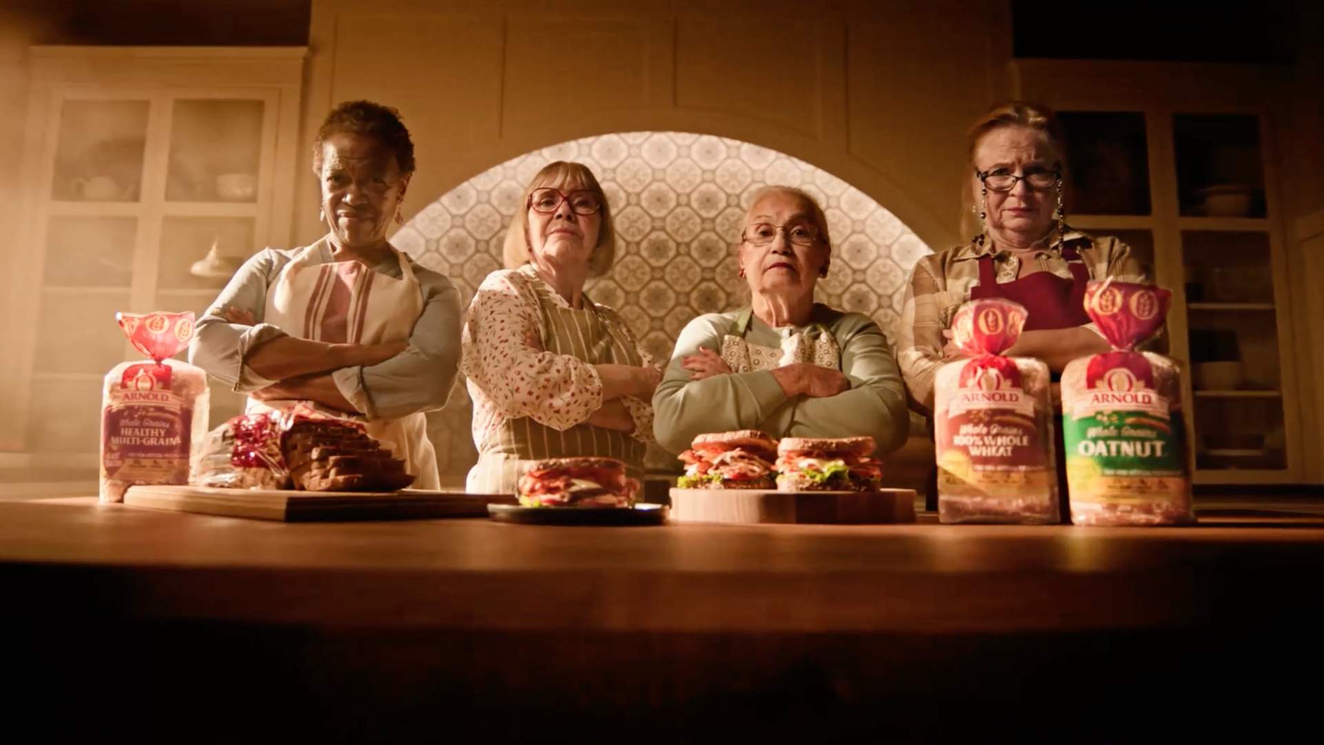 Four women in kitchen with Arnold bread and sandwiches